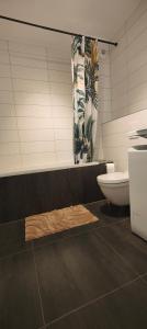a bathroom with a toilet and a shower curtain at Le Petit Eden - Bâle - Aéroport in Saint-Louis +44 photos