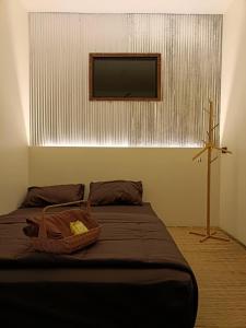 a bedroom with a bed with a television on the wall at Nana Pai in Mae Hong Son