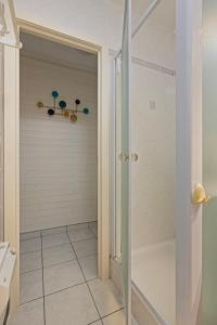 a walk in shower with a glass door in a bathroom at Atlantis 0102 in Sint-Idesbald +15 photos