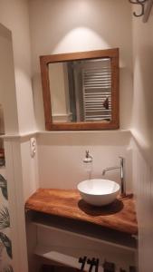 a bathroom with a sink and a mirror at 't Kabinet in Blankenberge +22 photos
