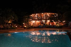 a house with a swimming pool at night at Argo by Trance in Dabolim