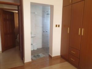 a bathroom with a shower and a sink at The Golden Enclave Nakuru Fully Furnished Apartments in Nakuru +18 photos