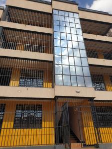 a tall building with yellow doors and windows at The Golden Enclave Nakuru Fully Furnished Apartments in Nakuru