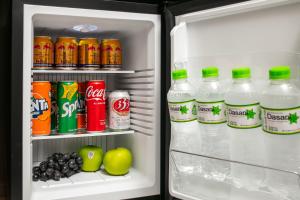 an open refrigerator filled with soda and drinks at Urban Alley Hotel in Hanoi