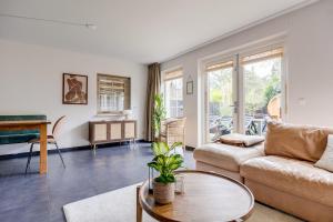 a living room with a couch and a table at Welkom in ons huisje in het bos met prive sauna in Lunteren
