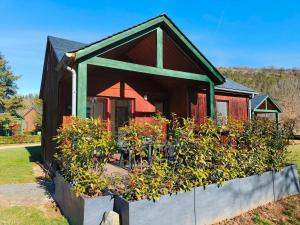 a house with a bunch of plants in front of it at Chalets de la Colagne in Chirac +22 photos
