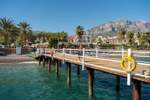 a wooden dock with a yellow slide in the water at AQI Hydros Club in Kemer