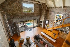 an overhead view of a living room with a brick wall at Secure, luxurious with lovely views in Pringle Bay