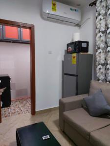 a living room with a couch and a refrigerator at Saceaas homes in Accra +13 photos