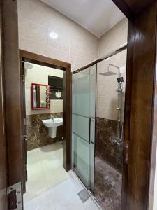 a bathroom with a glass shower and a sink at Osama Alnaser in Amman +50 photos