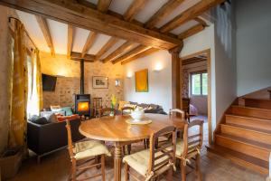 ein Wohnzimmer mit einem Holztisch und Stühlen in der Unterkunft Closerie de La Salière, gîte de charme et chambres d'hôtes, châteaux de la Loire, zoo de Beauval in Le Controis En Sologne