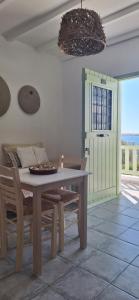 a dining room with a table and chairs and a door at Mike'sPlace in Antiparos