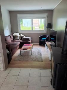 a living room with a couch and a table at 140 m2 , 3 lits 2 place et 1 canapé convertible 2 place in Lanvaudan