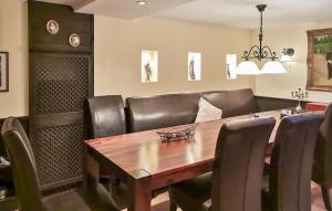 a dining room with a wooden table and leather chairs at Ferienhaus Mit Sauna in Fohnsdorf