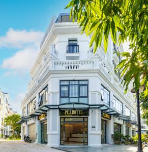 a white building with a store front at PCA HOTEL 1 - Vinhomes Ocean Park in Gia Lâm Pho