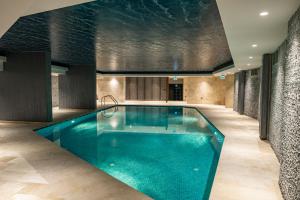 a large swimming pool in a building at Benesta Guest Teori in Istanbul
