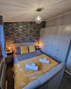 a bedroom with a bed with two towels on it at 4 Bed Luxury Lodge with Hot tub near Lake District in Warton +35 photos