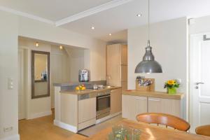 a kitchen with a table and a dining room at Bines Hues in List