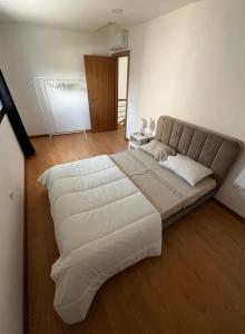 a bedroom with a large bed with white sheets at Maison Urgueira in Dornelas