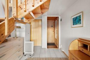 a hallway with wooden stairs in a house at Alkove Apartment in Tromsø