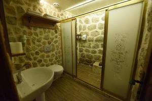 a bathroom with a toilet and a sink and a shower at Artuklu Kervansaray Hotel in Mardin
