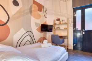 a hotel room with a bed and a chair at Déborah studio calme lit et place de parking in Rouen +20 photos