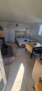 a bedroom with a bed and a table in it at Studio plein Sud au calme in Montauban