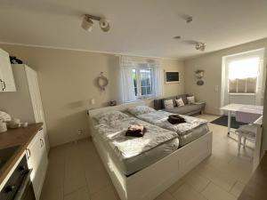 a bedroom with a bed and a couch at Heidelandhaus Zühlke mit gemütlicher Südterrasse in Soltau