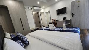 Postel nebo postele na pokoji v ubytování Hotel Akshaya