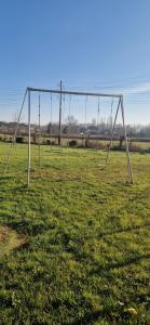 an empty swing set in an empty field at Studio plein Sud au calme in Montauban