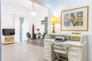 a living room with a desk with a computer on it at Renovated 5 Bdr House near Acropolis - New Beds, Terrace & Green Yard in Athens