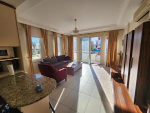 A television and/or entertainment centre at Antalya belek 4 nirvana club first floor two bedrooms pool view with water slide close to center - belek beach park