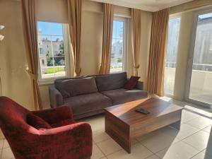 A seating area at Antalya belek 4 nirvana club first floor two bedrooms pool view with water slide close to center - belek beach park
