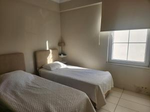 A bed or beds in a room at Antalya belek 4 nirvana club first floor two bedrooms pool view with water slide close to center - belek beach park