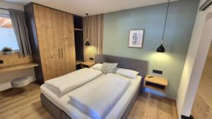 a bedroom with a large bed and a table at Apartment Sunplatzl in Forstau