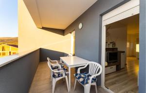 a small balcony with a table and two chairs at Stunning Apartment In Gornji Karin in Gornji Karin