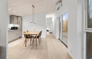 a kitchen and dining room with a table and chairs at 2 Bedroom Pet Friendly Home In Vemb in Vemb +16 photos