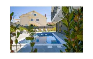 a swimming pool in the backyard of a house at 4 Bedroom Stunning Home In Murter in Murter