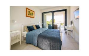 a bedroom with a bed and a desk and a window at 4 Bedroom Stunning Home In Murter in Murter