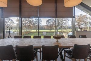 a large dining room with a large table and chairs at De Zwaluwhoeve in Peer
