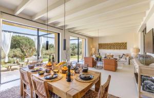 a dining room with a table and a living room at Ses Moreres in Llubí