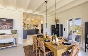 a dining room with a wooden table and chairs at Ses Moreres in Llubí