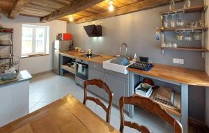 a kitchen with a counter and a sink and a table at 2 Bedroom Cozy Home In Plumieux in Plumieux