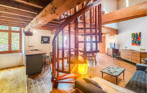 a living room with a loft with wooden beams at 2 Bedroom Awesome Home In Les Cabannes in Les Cabannes +10 photos