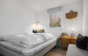 a white bedroom with a bed and a window at Nice Home In Kalundborg With Wifi in Kalundborg +13 photos