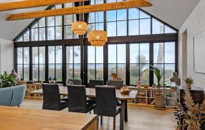 a dining room with large windows and a table and chairs at Nice Home In Odder With House Sea View in Odder