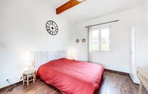a bedroom with a red bed and a clock on the wall at Stunning Home In Bussière-Badil in Bussière-Badil +18 photos