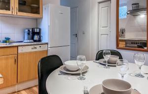a kitchen with a table with wine glasses on it at Pet Friendly Home In Dirkshorn in Dirkshorn
