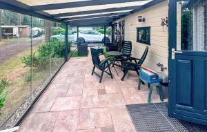 a patio with chairs and a table on a house at Amazing Stacaravan In Doornspijk in Doornspijk