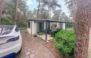 a small house with a car parked in front of it at Amazing Stacaravan In Doornspijk in Doornspijk